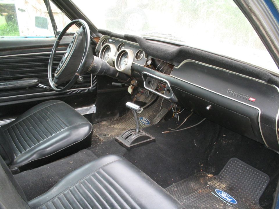 1967 Ford Mustang interior with black seats and dashboard