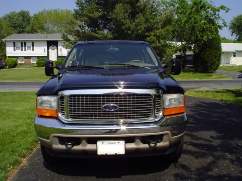 2000 Ford Excursion - This Ford Excursion is parked in front of a suburban house on a sunny day.