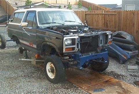 1986 Ford Bronco - This Ford Bronco is undergoing repairs, with its engine exposed and front bumper removed.