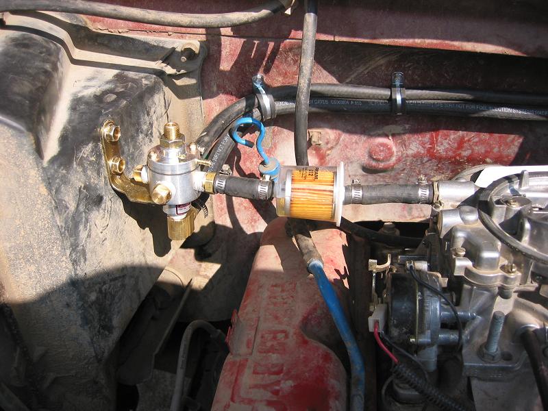 Adjustable fuel pressure regulator and clear Fram inline fuel filter mounted in engine bay