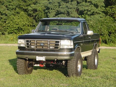 1993 Ford Bronco - This lifted 1992 Ford Bronco is shown from the front in a grassy field.