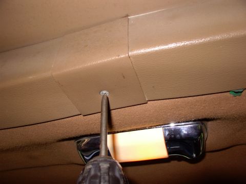 1986 Ford Bronco - First pull the center bolt cover trim off with a philips.
