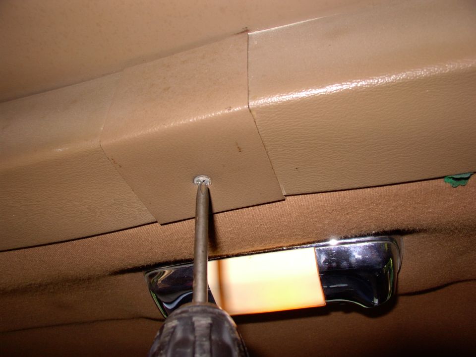 First pull the center  bolt cover trim off with a philips.
