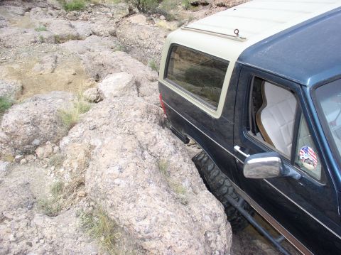 1993 Ford Bronco - This Ford Bronco is shown off-roading through a rocky, arid landscape.