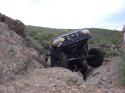 1993 Ford Bronco - A 1993 Ford Bronco is shown navigating a difficult rocky terrain, with one wheel off the ground.