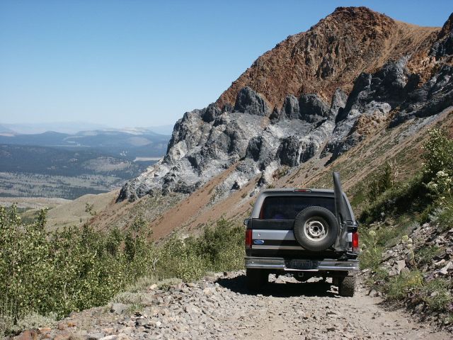 Rear view of a gray 1996 Ford Bronco on a mountain road