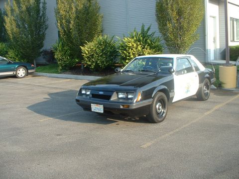 1999 Ford Crown Victoria - 1985 CHP Mustang.
