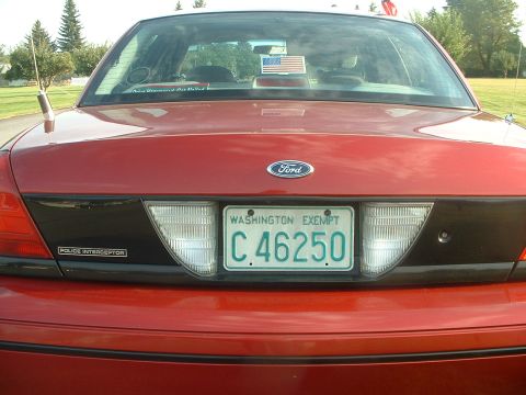1999 Ford Crown Victoria - This red Ford Crown Victoria Police Interceptor displays a Washington Exempt license plate.