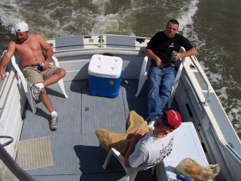 1994 Ford Bronco - Three men enjoy a ride on a boat, with a cooler and drinks onboard.