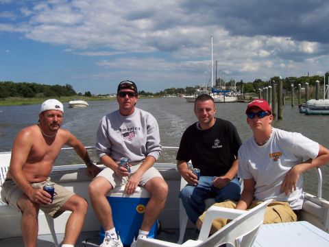 1994 Ford Bronco - A group of men enjoy a day on the water, with several boats visible in the marina.