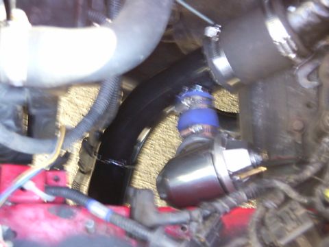 1990 Ford Bronco - Close-up view of engine components including hoses and a blow-off valve, with a visible Supermotors.net watermark.