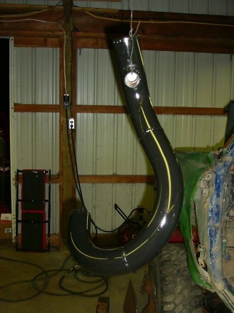 1990 Ford Bronco - Custom exhaust pipe with yellow accent stripes, suspended in a workshop.