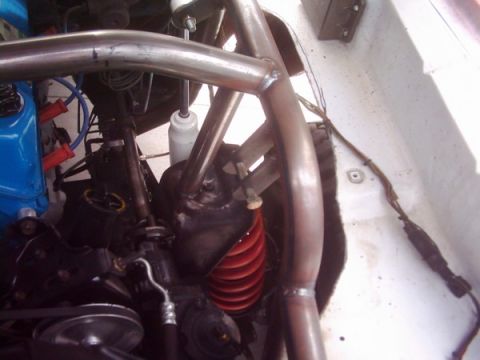 1978 Ford Bronco - Close-up view of a vehicle's engine bay, highlighting the roll cage and suspension components.