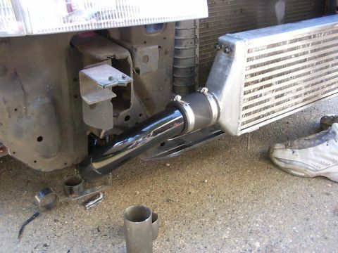 1990 Ford Bronco - Installing aftermarket intercooler piping on a vehicle's front end.