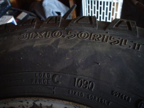 1993 Ford Bronco - Close-up of a tire's sidewall, revealing its size and manufacturing date code.