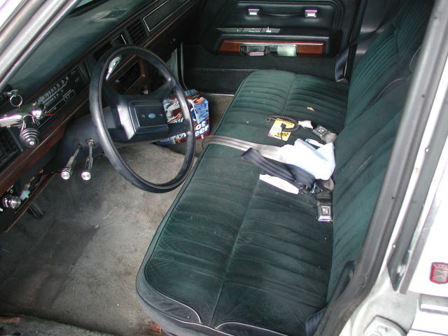 Interior view of a 1988 Ford Crown Victoria showing the steering wheel, dashboard, and front seats