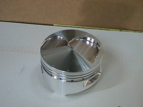 1979 Ford Bronco - Close-up of a shiny, custom engine piston, likely for a performance build.