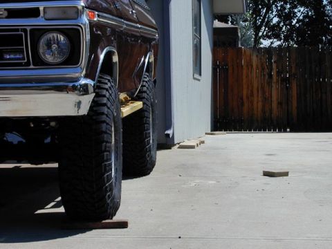 1979 Ford Bronco - Front view of a brown 1979 Ford Bronco, highlighting its large tires and chrome grille.