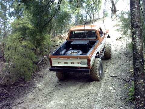1994 Ford Bronco - This lifted Ford pickup truck navigates a muddy, wooded trail.