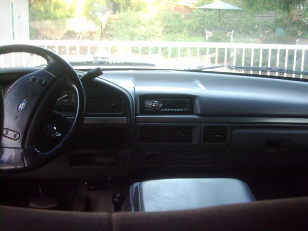 Vehicle interior dashboard with steering wheel, radio, and air vents
