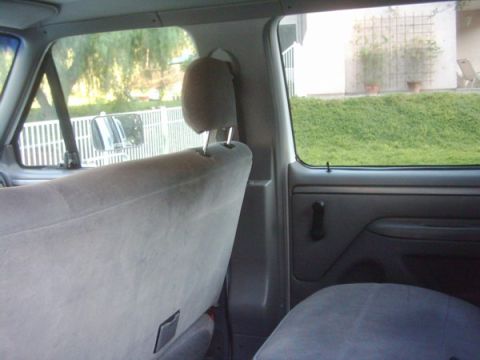 1978 Ford Bronco - Interior view of a vehicle, showing gray seats and a view through the windows. A watermark for SuperMotors is visible.