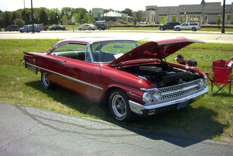 1967 Ford LTD - This red 1960 Ford Galaxie convertible is displayed with its hood open, revealing the engine bay.