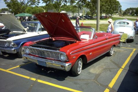 1967 Ford LTD - Red 1963 Ford Falcon convertible at a car show, hood up, parked next to another classic car.