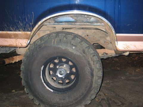 1995 Ford Bronco - Side view of the rear wheel well and tire of a 1995 Ford Bronco.