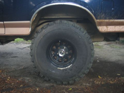 1995 Ford Bronco - Close-up of the front wheel well and tire on a 1995 Ford Bronco.