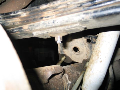 1995 Ford Bronco - Undercarriage view shows vehicle suspension parts including leaf springs and a shock absorber.
