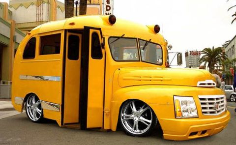 1996 Ford Bronco - This custom yellow bus features a modern front end and chrome wheels.