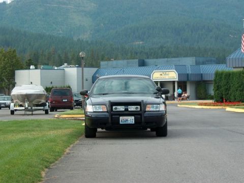2001 Ford Crown Victoria - A black 2001 Ford Crown Victoria police car is parked in front of a conference center.