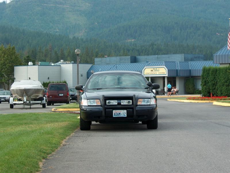 Black 2001 Ford Crown Victoria police car with a push bar, parked on asphalt