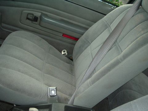 1989 Ford Escort - Interior view of a car seat and door panel.