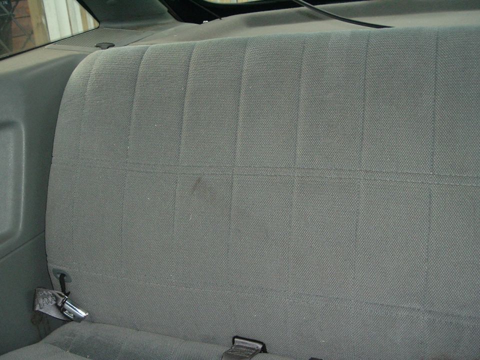 Gray fabric rear seat with seatbelt buckles
