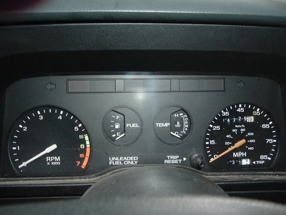 Car dashboard with tachometer, fuel gauge, temp gauge, and speedometer showing 147291 miles