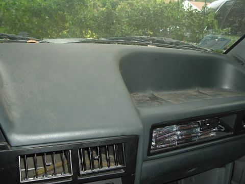 1989 Ford Escort - The interior of a 1989 Ford Escort is visible, with a sticker on the windshield.