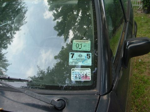 1989 Ford Escort - The windshield displays several Texas inspection stickers, with the latest visible one indicating the year 2005.