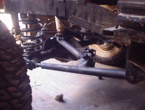 1989 Ford Bronco - The front suspension and tire of a 1989 Ford Bronco are visible in this close-up shot.