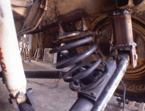 1989 Ford Bronco - Rear suspension components, including a coil spring and shock absorber, are visible in this close-up shot.