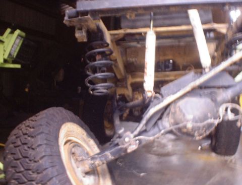 1989 Ford Bronco - Close-up of a vehicle's rear axle and suspension components, showing the coil spring and shock absorber.