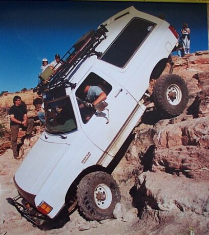1990 Ford Bronco - This vehicle is navigating a challenging rocky terrain, with several people observing the action.