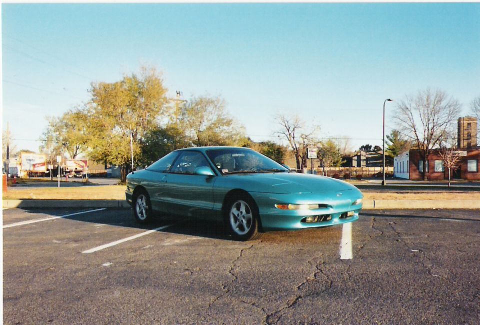 Teal 1993 Ford Probe parked in a lot, front 3/4 view