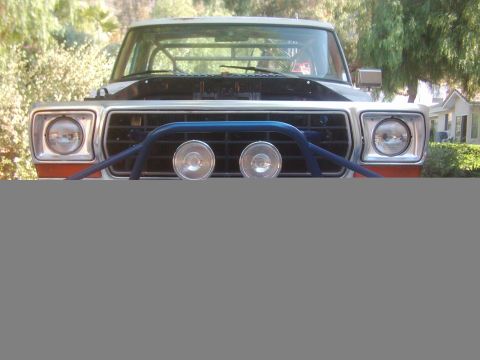 1978 Ford Bronco - The front of a Ford Bronco is shown with a custom bull bar and lights, suggesting off-road modifications.