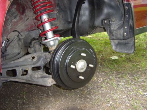 1998 Ford Taurus - Close-up of a vehicle's rear suspension and braking system, showing a drum brake.