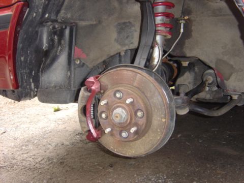 1998 Ford Taurus - Front wheel assembly showing brake components and suspension parts.