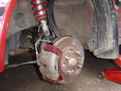 1998 Ford Taurus - The image shows a close-up view of a vehicle's brake assembly, including the rotor, caliper, and suspension components.