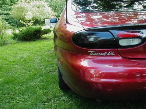 1997 Ford Taurus - Rear view of a red 1997 Ford Taurus GL, a modified black tail light and 'Taurus GL' badging.