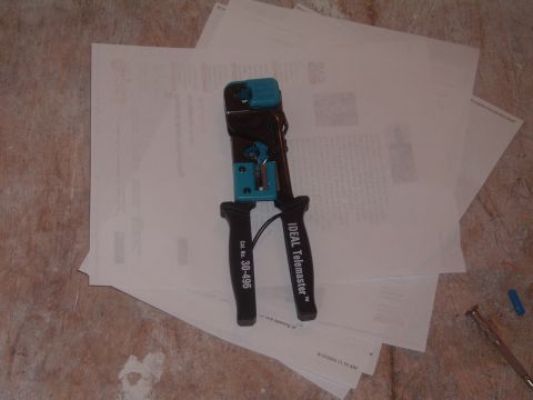 2000 Honda Accord - A close-up view shows a crimping tool placed on top of several sheets of paper.