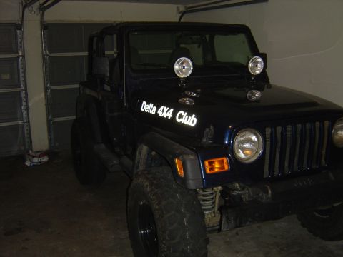 2002 Jeep Wrangler - This 2002 Jeep Wrangler is shown in a 3/4 front view, the "Delta 4X4 Club" text on its hood.